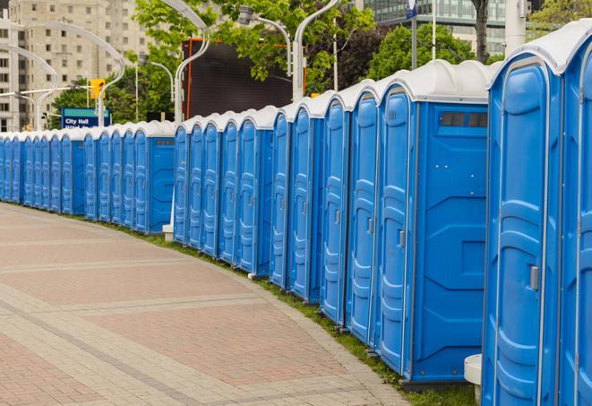 a row of portable restrooms set up for a large athletic event, allowing participants and spectators to easily take care of their needs in Ephrata, PA